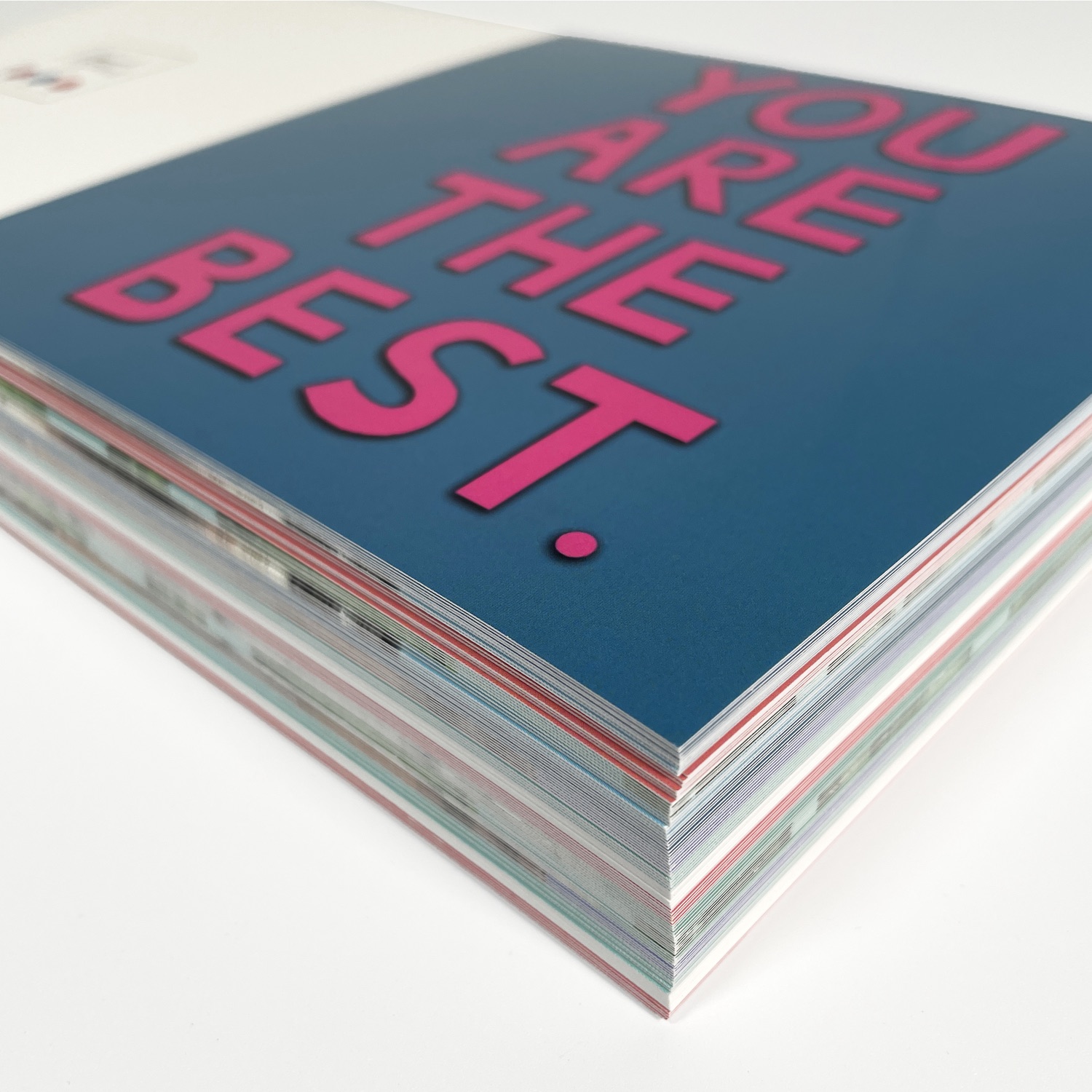 A stack of colourful printed greeting cards