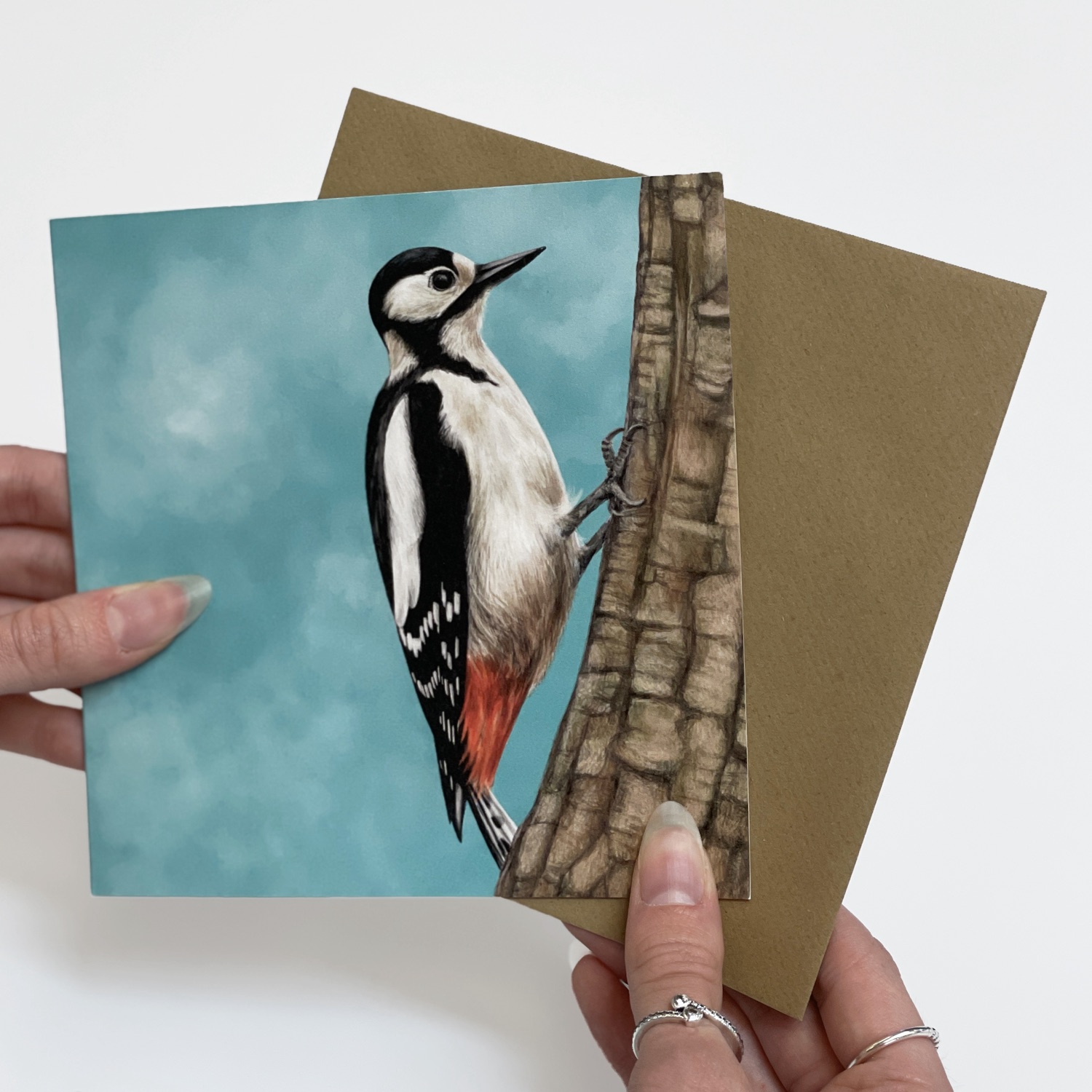 A painted great spotted woodpecker greeting card