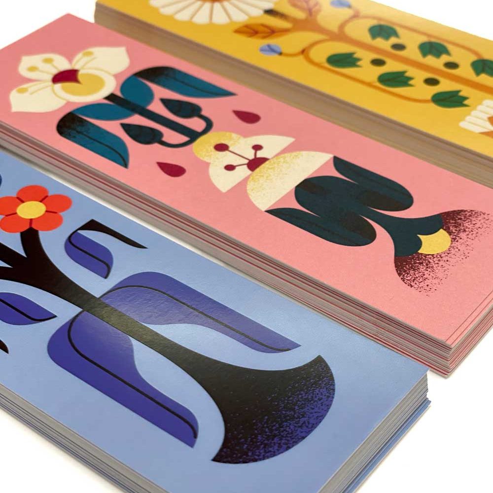 Stacks of printed floral bookmarks in blue, pink and yellow